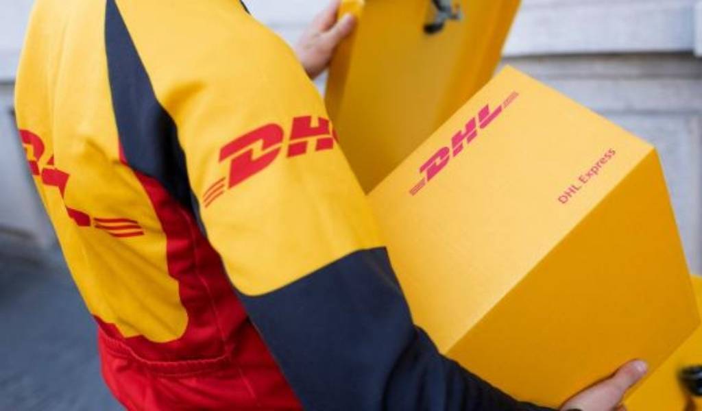 DHL delivery person carrying yellow package
