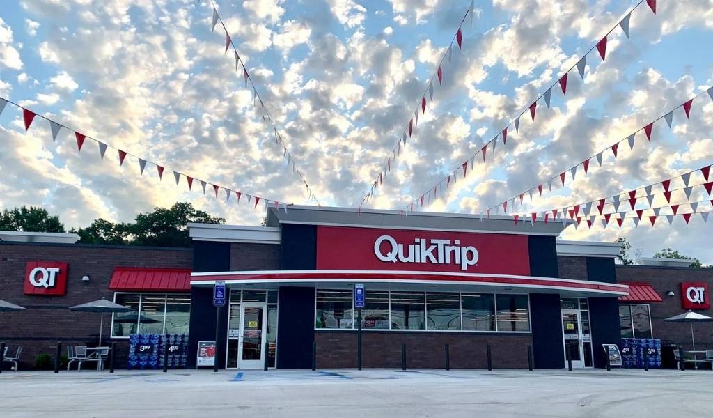 a QuikTrip store with banner flags in the winter