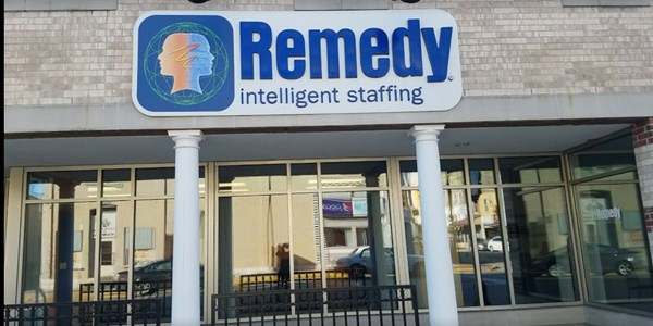 Remedy Staffing building with white columns and windows
