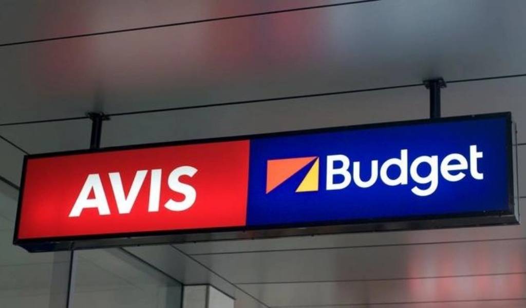 an Avis Budget Group sign at an airport