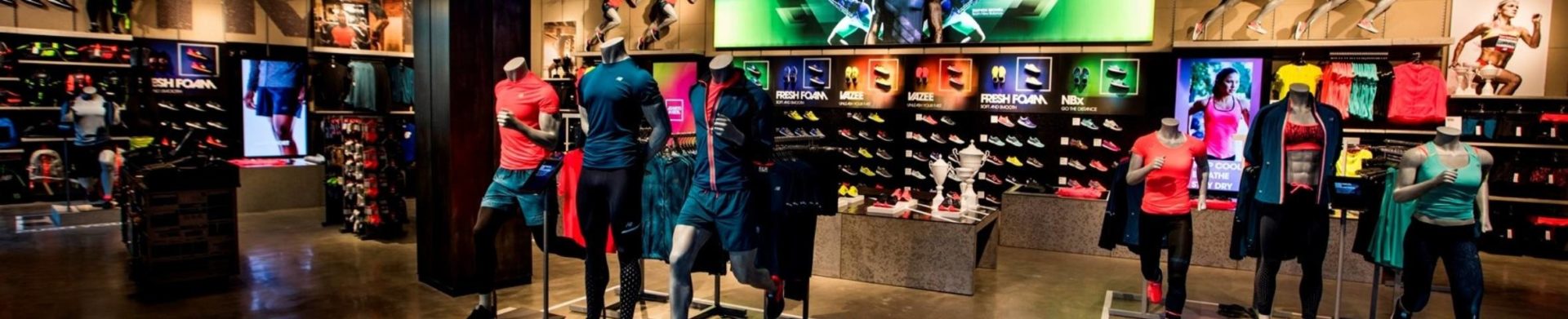 a New Balance store interior with clothes and shoes